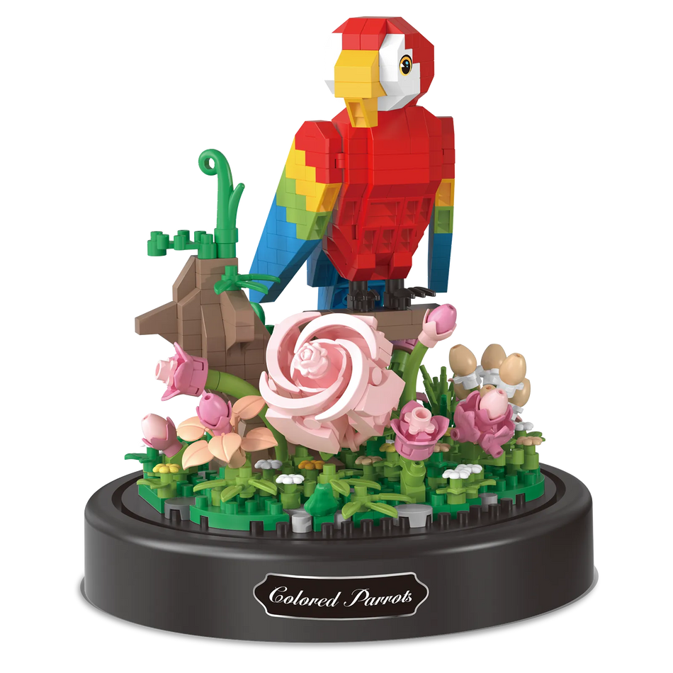 Produktfoto der Balody Miniblocks roter Papagei sitzend auf einem Zweig mit Blumen unter einer Glocke