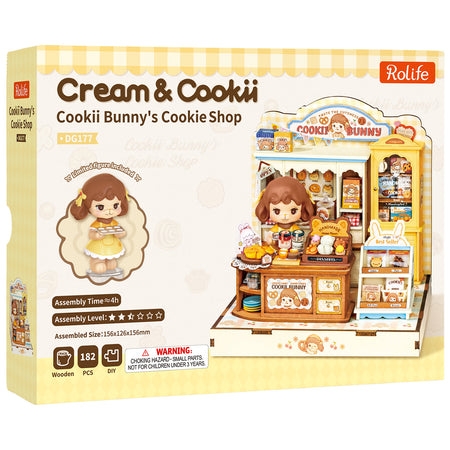 Vorderseite der Verpackung der Robotime Cookii Bunny’s Cookie Shop, Miniaturhaus einer Keksladen mit Cookii Bunny hinter der Theke