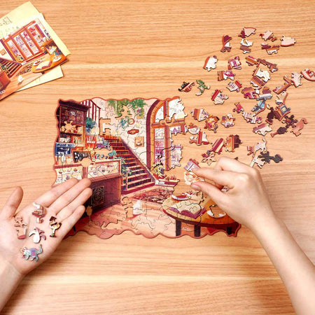 Eine Person ist damit beschäftigt, das Robotime Cozy Winter Café Puzzle zu erstellen
