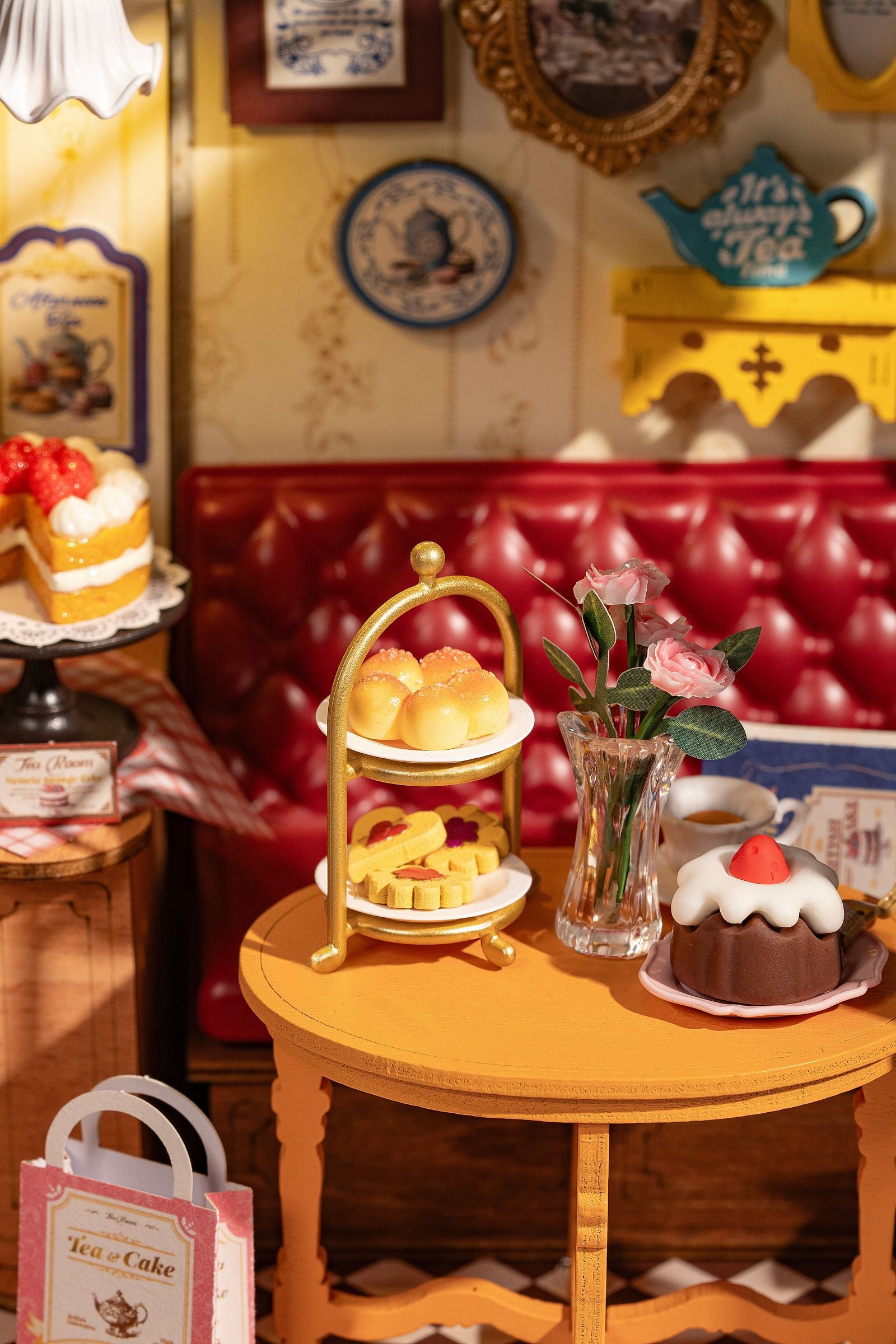 Detail eines Tisches mit Kuchen und Blumenstrauß des Robotime Leisure Time Tea Room