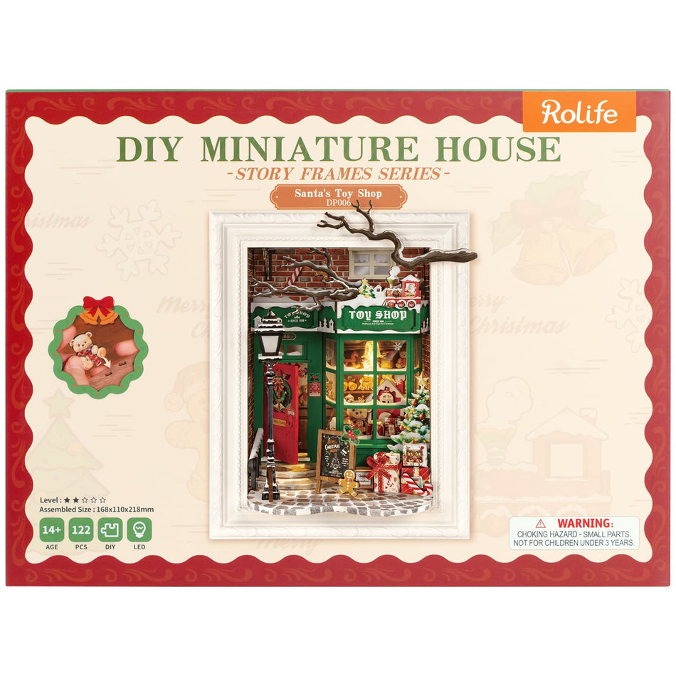 Vorderseite der Verpackung der Robotime Santa’s Toy Shop, Diorama eines weihnachtlich dekorierten Ladens mit Lichtern